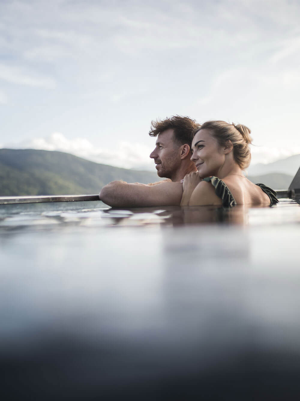 Hotel with pool in Terento - man & woman enjoy the view - Hotel Terentnerhof