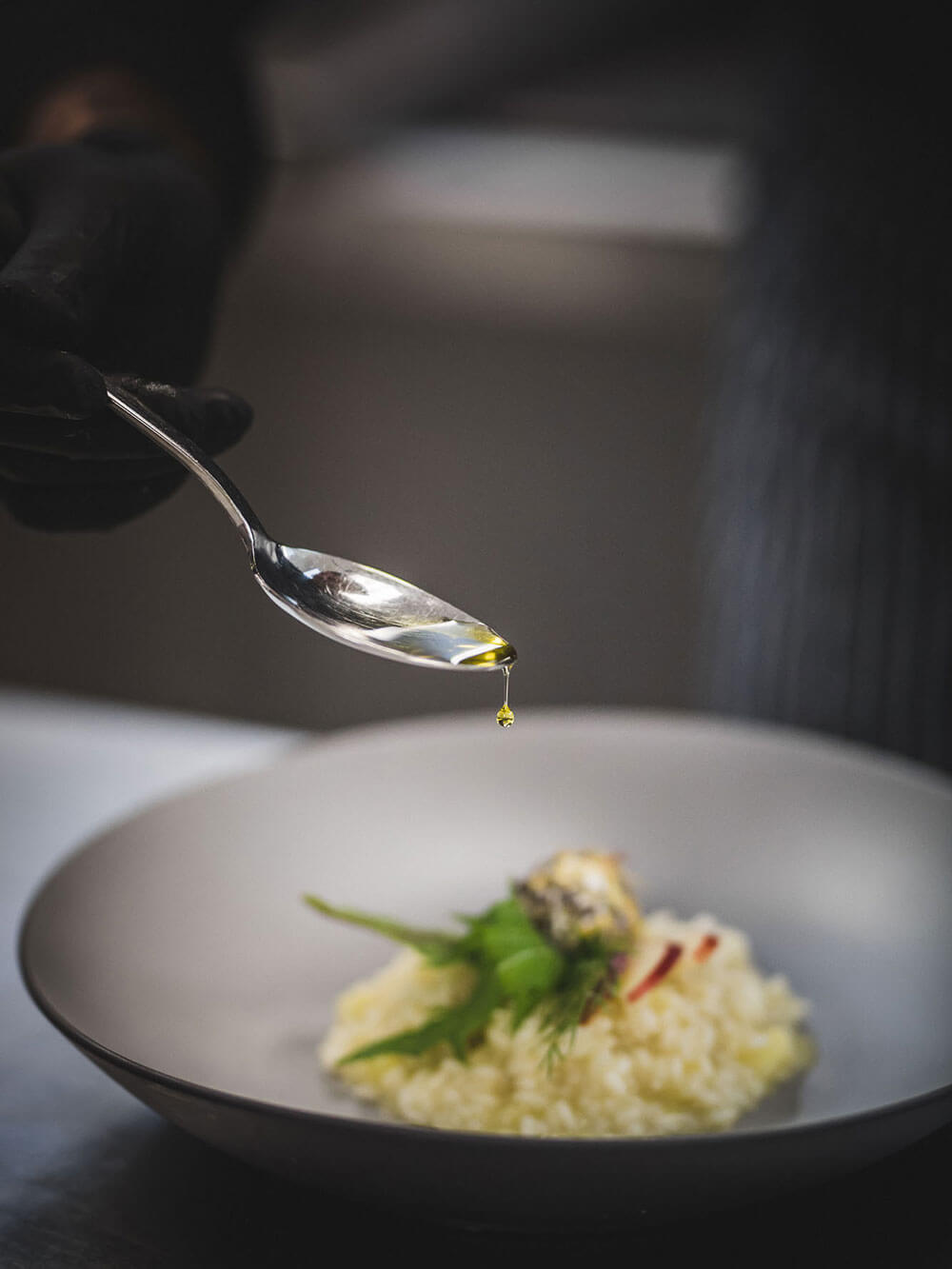 Culinary delights - detail photo - spoon with oil and plate with dish - Hotel Terentnerhof